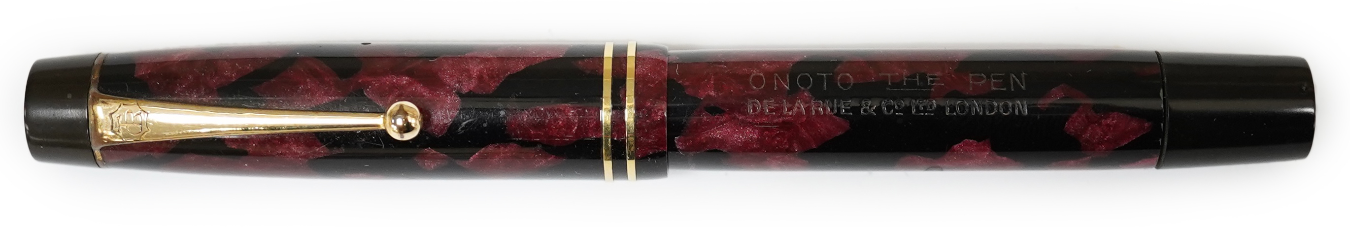 A De La Rue Onoto black and red marble piston filler with 14ct. gold No.4 nib